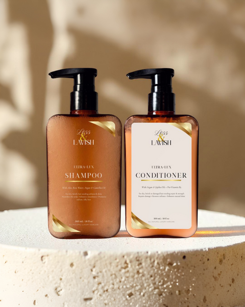 Two bottles of Less & Lavish shampoo and conditioner on a textured surface with a neutral background.