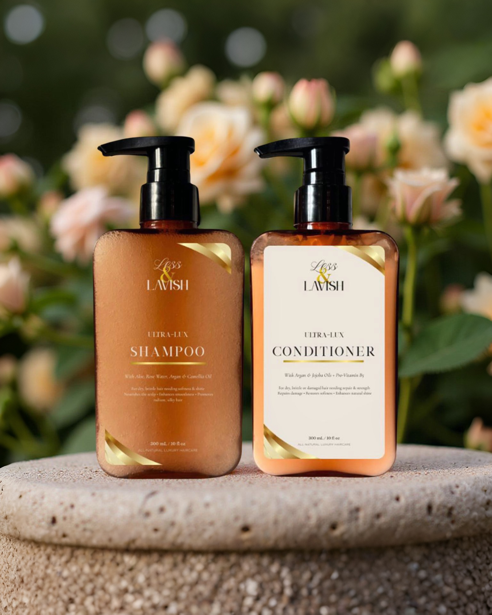 Two bottles of  Less & Lavish Shampoo and Conditioner Duo on a stone surface with flowers in the background.