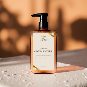 Less & Lavish Ultra-Lux Conditioner bottle with pump on a textured surface and blurred background
