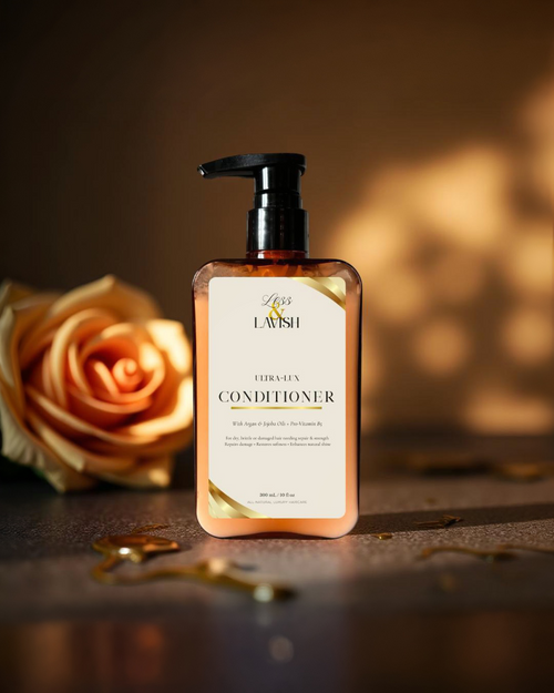 Less & Lavish Ultra-Lux Conditioner bottle with a rose on a stone surface, oil dripping