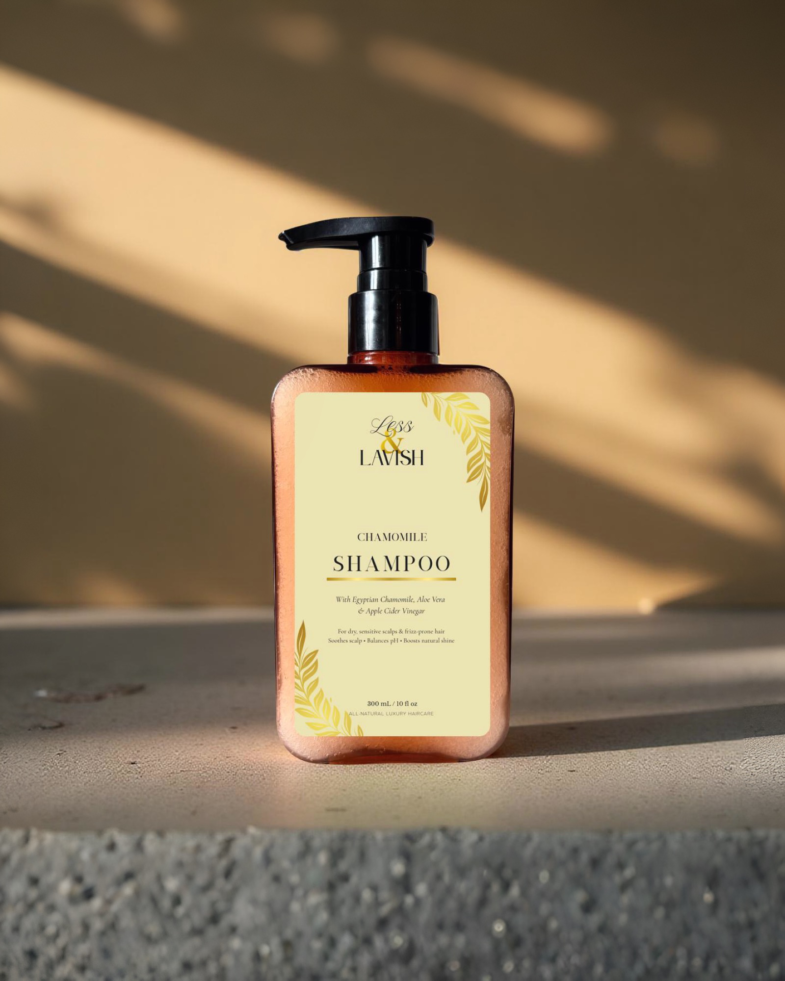 Less & Lavish Chamomile Shampoo bottle on a textured surface with a neutral background